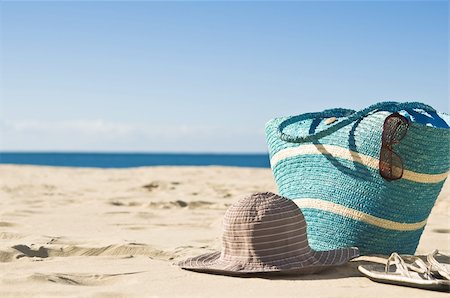 summer beach break - A view of the beach. Focus on the foreground,with bag, hat, sunglasses and sandals. Stock Photo - Budget Royalty-Free & Subscription, Code: 400-05231373