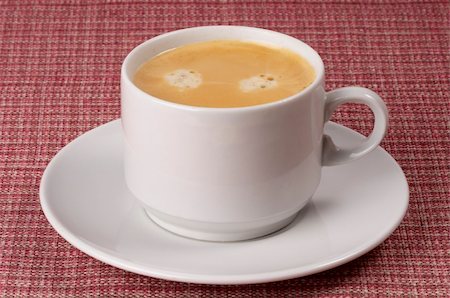 simsearch:628-02615924,k - Little white espresso coffee cup on a white saucer over checked table-cloth background Foto de stock - Royalty-Free Super Valor e Assinatura, Número: 400-05231508
