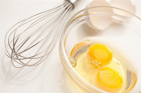 Hand Mixer with Eggs in a Glass Bowl on a Reflective White Background. Stock Photo - Budget Royalty-Free & Subscription, Code: 400-05231767