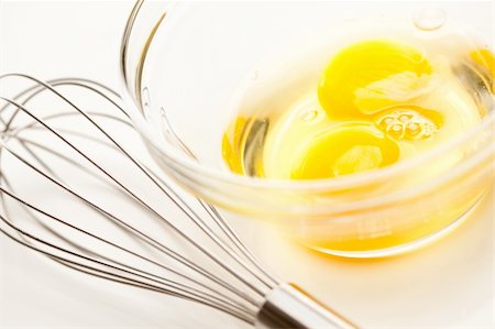 simsearch:400-05231767,k - Hand Mixer with Eggs in a Glass Bowl on a Reflective White Background. Photographie de stock - Aubaine LD & Abonnement, Code: 400-05231762