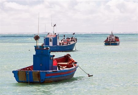 simsearch:400-06738203,k - Colourful traditional fishing boats in harbour with the ocean and clouds in the background Stock Photo - Budget Royalty-Free & Subscription, Code: 400-05231771