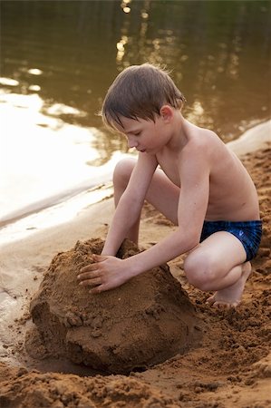 The boy builds on sand Stock Photo - Budget Royalty-Free & Subscription, Code: 400-05232199
