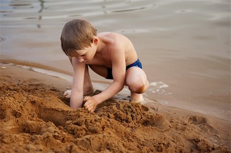 The boy builds on sand Stock Photo - Budget Royalty-Free & Subscription, Code: 400-05232200