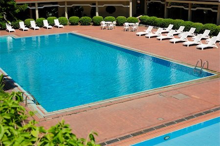 swimming pool side furniture images - swimming pool and chaise longues with a  long summerhouse around Foto de stock - Super Valor sin royalties y Suscripción, Código: 400-05232240