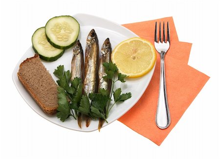 pickled lemon - Smoked fishes with lemon, cucumber and green parsley on white plate. Close-up. Isolated on white background. Studio photography. Stock Photo - Budget Royalty-Free & Subscription, Code: 400-05232345
