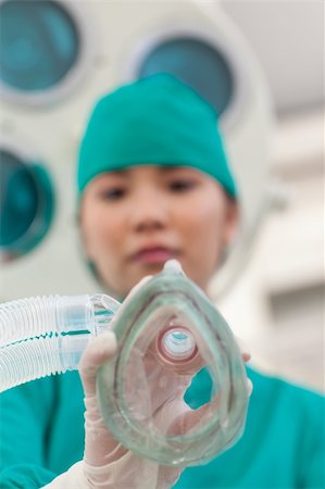 Confident doctor applying gas mask to a patient in the hospital Stock Photo - Budget Royalty-Free & Subscription, Code: 400-05232835