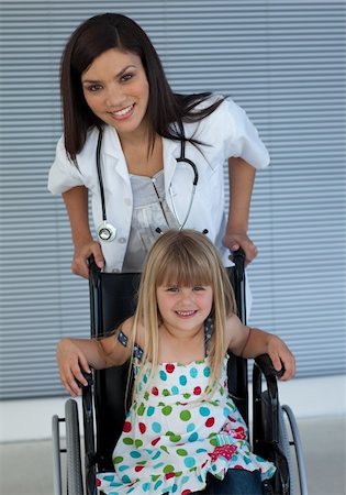 sprained her ankle - Portrait of a little girl on a wheelchair and a young doctor in the hospital Stock Photo - Budget Royalty-Free & Subscription, Code: 400-05232836