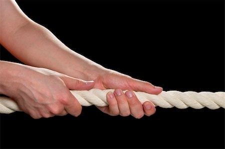 Tight the rope with two hands macro shot isolated over black background Fotografie stock - Microstock e Abbonamento, Codice: 400-05233387