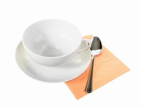 White empty mug and spoon on orange paper napkin. Isolated on white. Close-up. Studio photography. Stock Photo - Budget Royalty-Free & Subscription, Code: 400-05233596