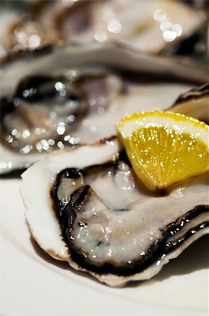 raw oyster - Close up on fresh oysters with lemon slide Stock Photo - Budget Royalty-Free & Subscription, Code: 400-05233615