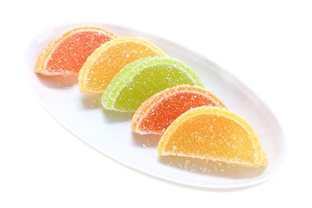 simsearch:400-05906235,k - Group of sweets as citrus fruits on white plate. Isolated on white background. Close-up. Studio photography. Stock Photo - Budget Royalty-Free & Subscription, Code: 400-05233680