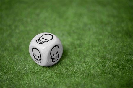 dice of bad luck - Bad luck is always here, skull dice over a green carpet Stock Photo - Budget Royalty-Free & Subscription, Code: 400-05233936