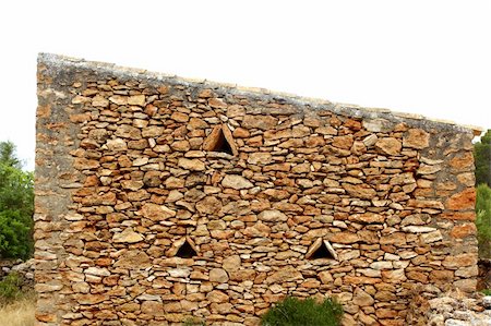 stone wall pattern - masonry stone wall triangle windows Formentera balearic islands Stock Photo - Budget Royalty-Free & Subscription, Code: 400-05244195