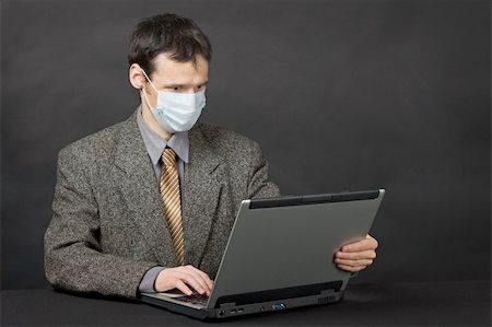 simsearch:400-05265698,k - Person protected medical mask when working in Internet Foto de stock - Super Valor sin royalties y Suscripción, Código: 400-05244251