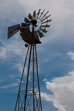 photosurfer (artist) - An old metal windmill stands in partial silhouette against the sky. Stock Photo - Budget Royalty-Free & Subscription, Code: 400-05245570