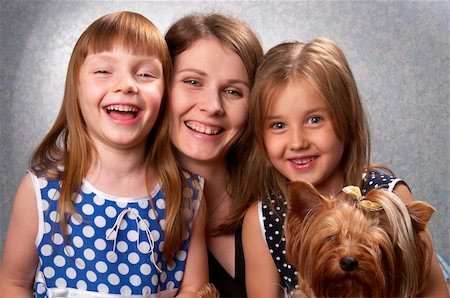 Young mother and two little sisters with Yorkshire terrier over light defocused background Fotografie stock - Microstock e Abbonamento, Codice: 400-05246613