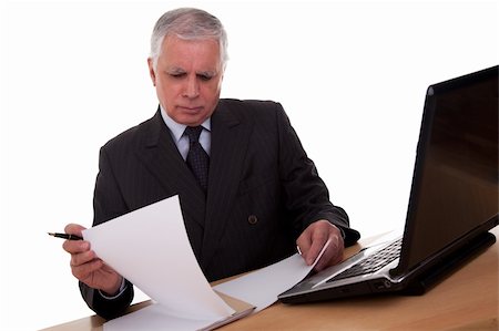 mature businessman  looking to computer, isolated on white background. Studio shot. Stock Photo - Budget Royalty-Free & Subscription, Code: 400-05247531