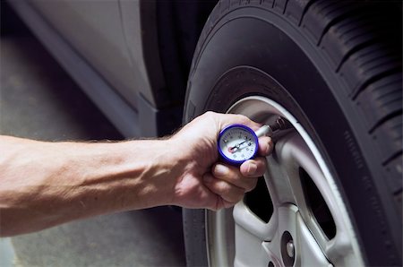 Mechanic checking tire pressure for increased gas milage Stock Photo - Budget Royalty-Free & Subscription, Code: 400-05248380
