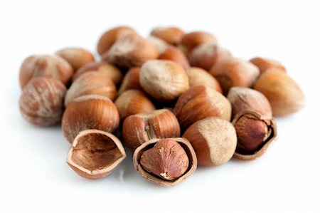 Closeup of whole and cracked hazelnuts. Isolated on white background. Stock Photo - Budget Royalty-Free & Subscription, Code: 400-05248440