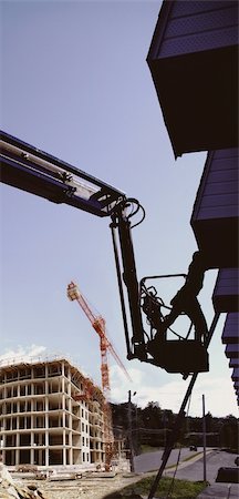 simsearch:400-05249204,k - silhouette construction worker on a manlift  industrial highrise building work in progress background .blue sky vertical panoramic format. Stock Photo - Budget Royalty-Free & Subscription, Code: 400-05249047