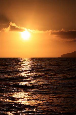 simas2 (artist) - Sunset over the sea by the coast Foto de stock - Royalty-Free Super Valor e Assinatura, Número: 400-05249177