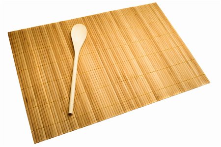Wooden spoon on mat of bamboo, isolated on white. Photographie de stock - Aubaine LD & Abonnement, Code: 400-05249769