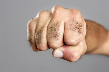 Hairy man fisht closeup expression over gray background Stock Photo - Budget Royalty-Free & Subscription, Code: 400-05240016