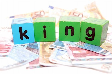 simsearch:400-05241318,k - assorted childrens toy letter building blocks against a white background on money that spell king Stock Photo - Budget Royalty-Free & Subscription, Code: 400-05241320