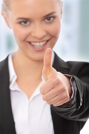 simsearch:400-05898224,k - Young business woman showing OK sign, looking at camera and smiling. Focus on hand Foto de stock - Royalty-Free Super Valor e Assinatura, Número: 400-05243397