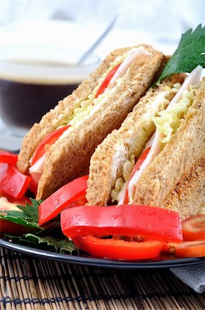 simsearch:400-04054010,k - fresh and delicious classic club sandwich over a black glass dish with coffee and vegetable Photographie de stock - Aubaine LD & Abonnement, Code: 400-05254229