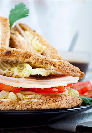 simsearch:400-04798472,k - fresh and delicious classic club sandwich over a black glass dish with coffee and vegetable Stock Photo - Budget Royalty-Free & Subscription, Code: 400-05254230