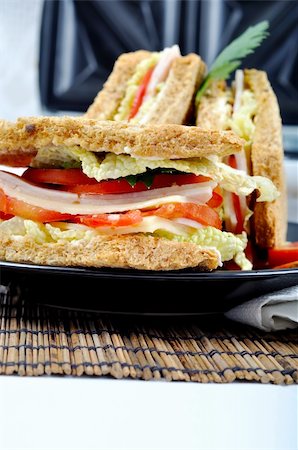 simsearch:400-04798472,k - fresh and delicious classic club sandwich over a black glass dish with coffee and toasters Stock Photo - Budget Royalty-Free & Subscription, Code: 400-05254232