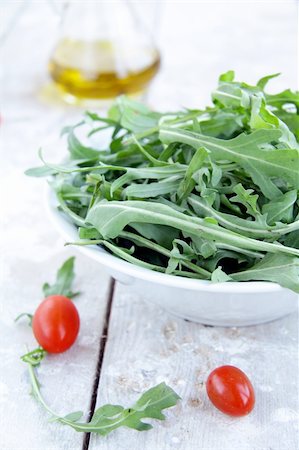 Arugula salad in a white cup with a cherry and olive oil Stock Photo - Budget Royalty-Free & Subscription, Code: 400-05254623