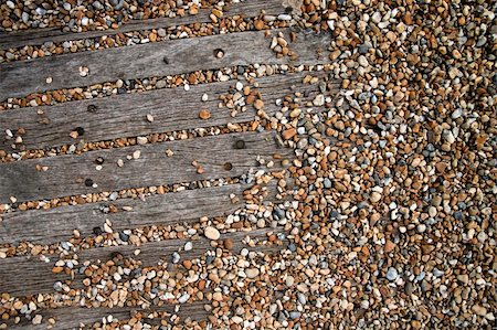 england brighton not people not london not scotland not wales not northern ireland not ireland - pebbles covering old wooden  pathway on brighton beach sussex england Stock Photo - Budget Royalty-Free & Subscription, Code: 400-05255079