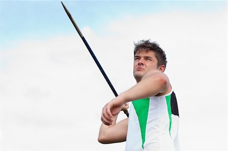 Handsome male athlete throwing a javelin outdoors Stock Photo - Budget Royalty-Free & Subscription, Code: 400-05256606