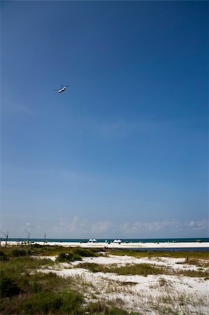 spilling water - Oil clean-up crews along a white beach in the Gulf Coast. Stock Photo - Budget Royalty-Free & Subscription, Code: 400-05257861