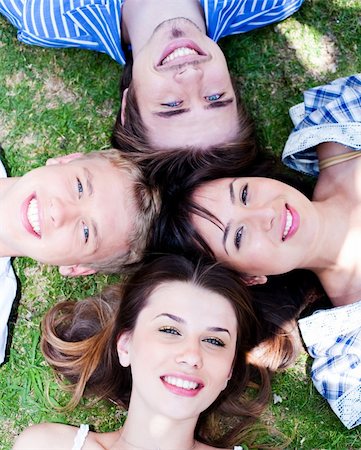 Young friends forming a circle making park as their bed Stock Photo - Budget Royalty-Free & Subscription, Code: 400-05258243