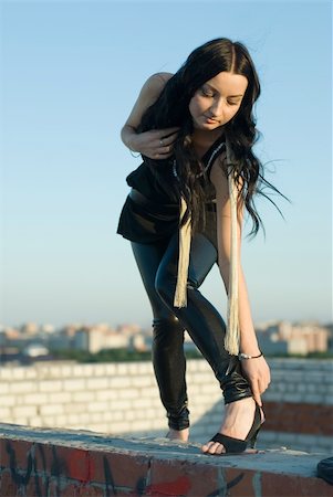 simsearch:400-04654369,k - The girl correcting a shoe on roof of building Stock Photo - Budget Royalty-Free & Subscription, Code: 400-05258582