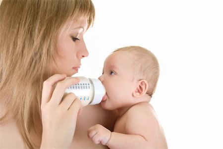 simsearch:400-05258814,k - Mother give drink her baby boy by feeding bottle over white Stock Photo - Budget Royalty-Free & Subscription, Code: 400-05258813