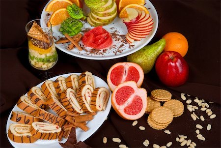 Set of sweet fruit and cake on a dark background Stock Photo - Budget Royalty-Free & Subscription, Code: 400-05258935