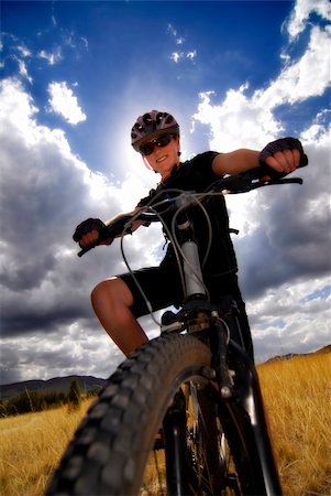 simsearch:400-06922980,k - Young Woman Riding Mountain Bike in Wilderness Stock Photo - Budget Royalty-Free & Subscription, Code: 400-05259200