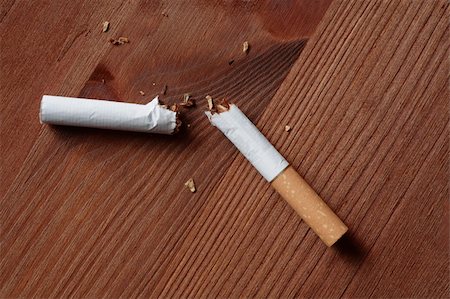 quitting - Broken cigarette closeup lying on wooden background Stock Photo - Budget Royalty-Free & Subscription, Code: 400-05259559