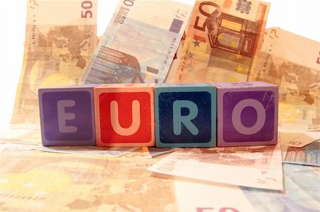 simsearch:400-05241318,k - toy letters that spell euro against a cash background Stock Photo - Budget Royalty-Free & Subscription, Code: 400-05259876