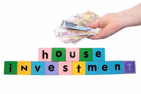 simsearch:400-05241318,k - toy letters that spell house investment with cash in hand against a white background with clipping path Stock Photo - Budget Royalty-Free & Subscription, Code: 400-05259880
