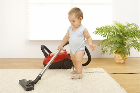 Baby boy cleaning the carpet with vacuum cleaner Stock Photo - Budget Royalty-Free & Subscription, Code: 400-05251560