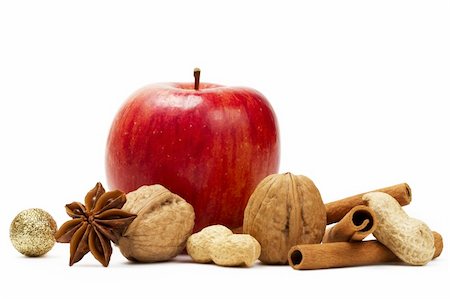 red apple, star anise, cinnamon sticks and some nuts  on white background Stock Photo - Budget Royalty-Free & Subscription, Code: 400-05252546