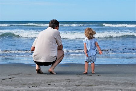 Father and daughter watching the ocean on the beach - North Island - New Zealand Photographie de stock - Aubaine LD & Abonnement, Code: 400-05252724