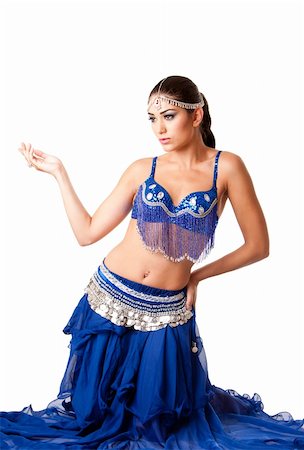 Beautiful Israeli Egyptian Lebanese Middle Eastern fashion belly dancer performer in blue skirt and bra sitting on knees, isolated. Photographie de stock - Aubaine LD & Abonnement, Code: 400-05252992