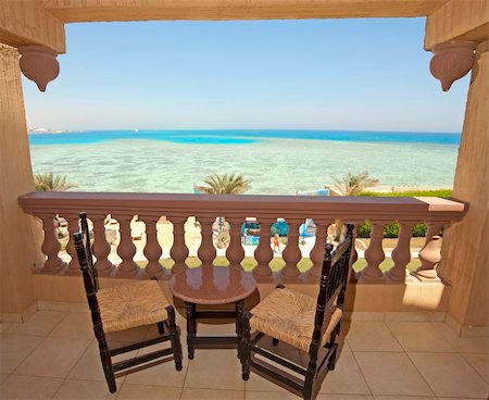 View from the balcony of a luxury hotel in a tropical resort showing the ocean and swimming pool Stock Photo - Budget Royalty-Free & Subscription, Code: 400-05253025