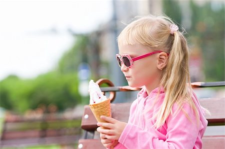 Little blond girl eating ice-cream Stock Photo - Budget Royalty-Free & Subscription, Code: 400-05253994